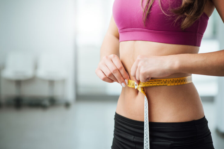 7 Best Stomach Wraps 2021 - Review and Buying Guide 17 Slim woman measuring her thin waist
